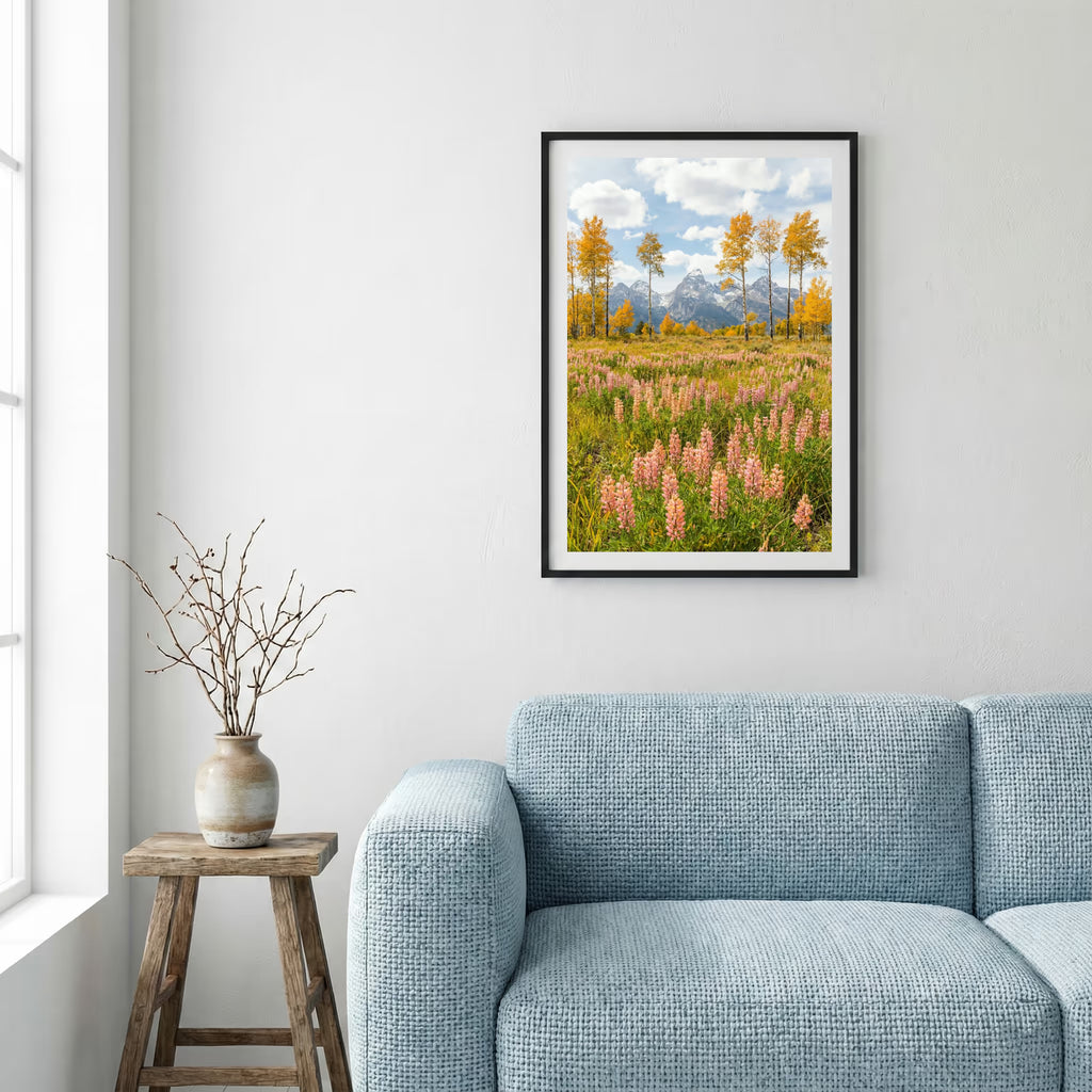 Jagged alpine peaks rising above a green valley dotted with autumn-colored trees — framed canvas wall art in a wooden frame, 16×24 in