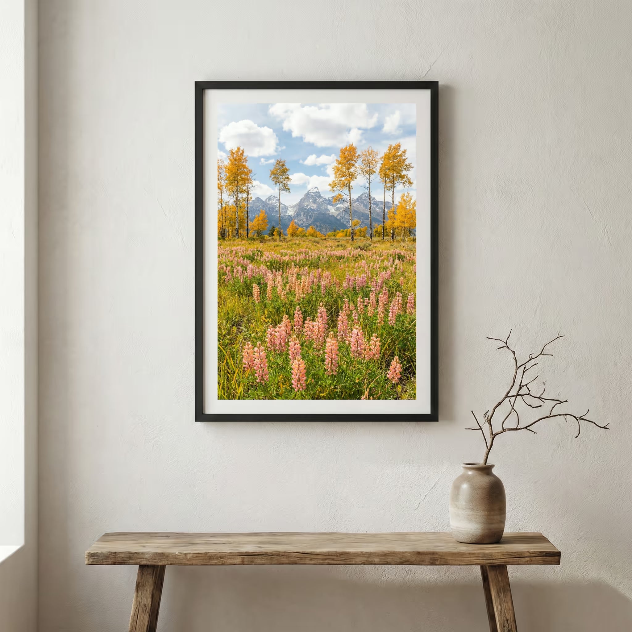 Jagged alpine peaks rising above a green valley dotted with autumn-colored trees — wooden frame canvas wall art print, 12×18 in