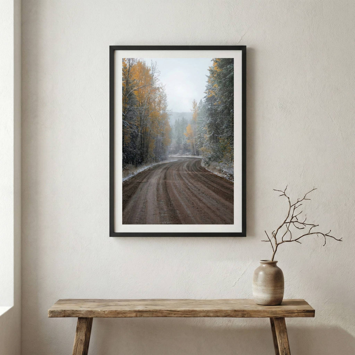 Dirt forest road scattered with autumn leaves and an early dusting of snow — wooden frame canvas wall art print, 12×18 in