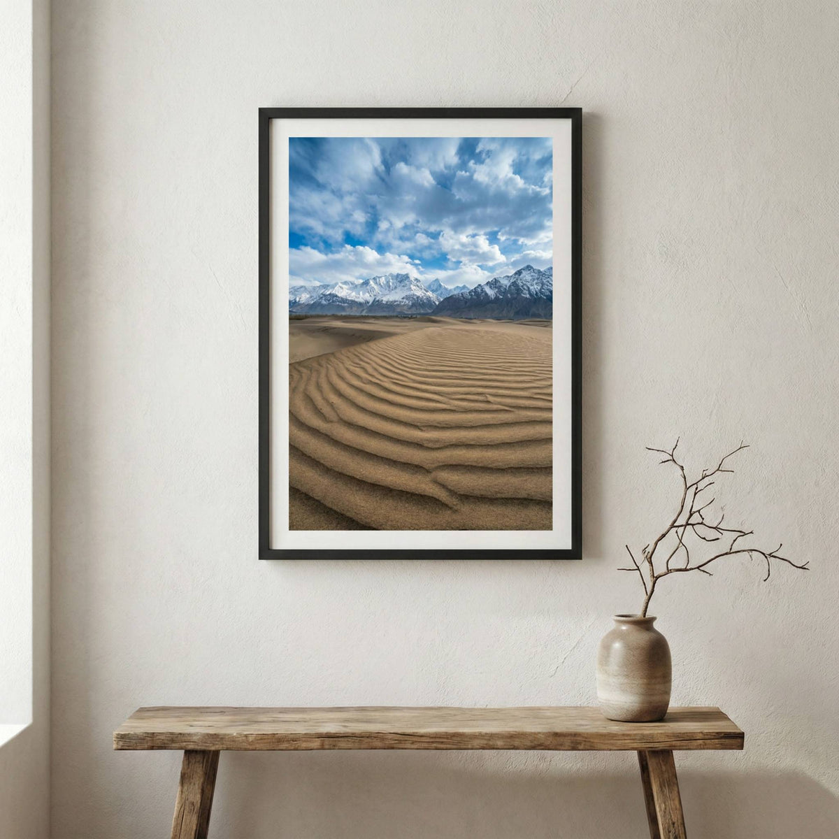Rippled cold-desert dunes leading toward a dramatic, snow-capped mountain range — wooden frame canvas wall art print, 12×18 in