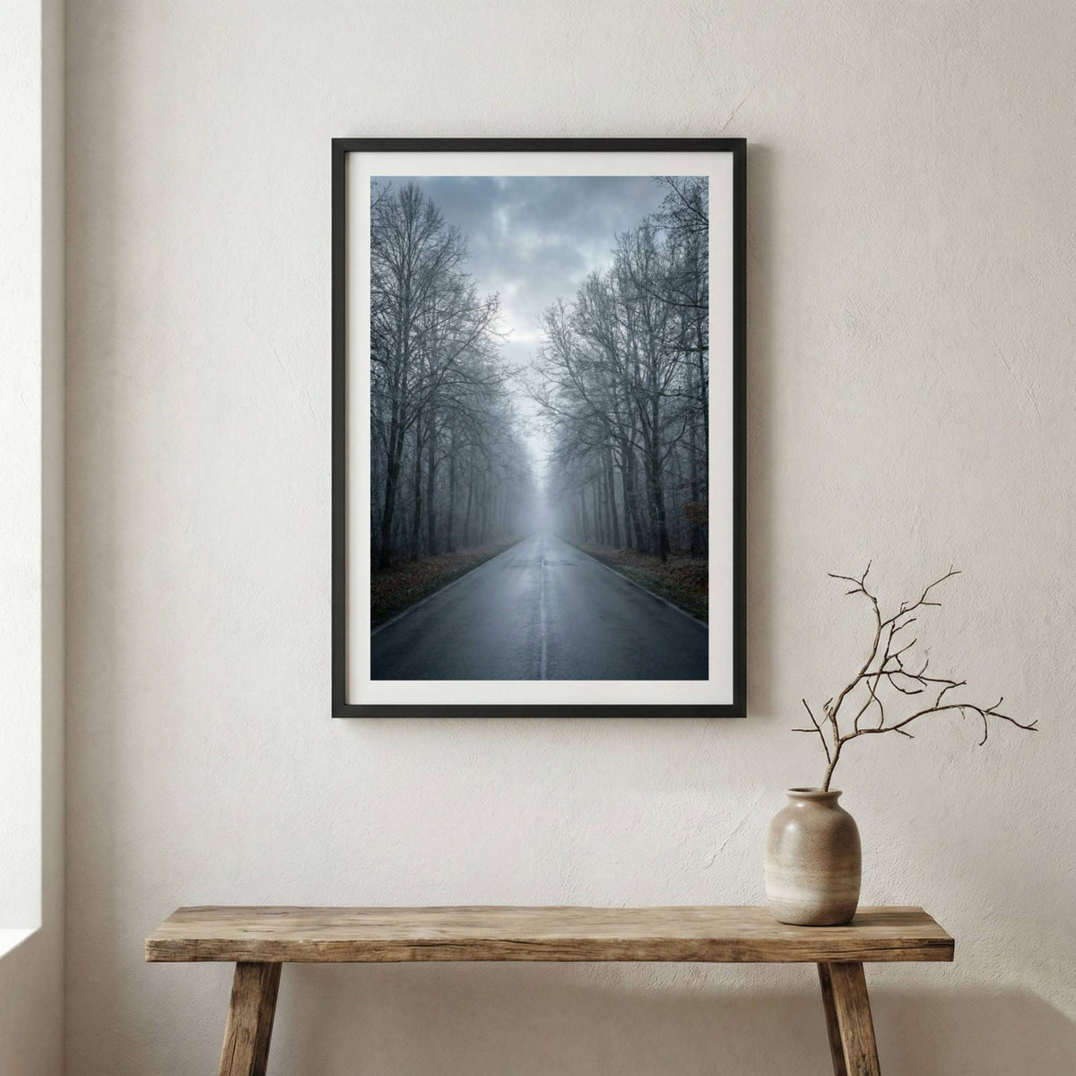 Row of bare, leafless trees lining a road in thick fog — wooden frame canvas wall art print, 12×18 in