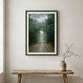 Row of bare, leafless trees lining a road in thick fog — wooden frame canvas wall art print, 12×18 in
