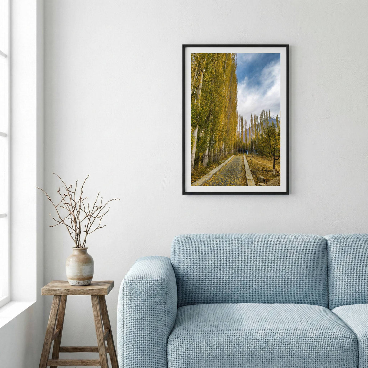 Stone-walled walkway lined with golden poplar trees leading toward the mountains — framed canvas wall art in a wooden frame, 16×24 in