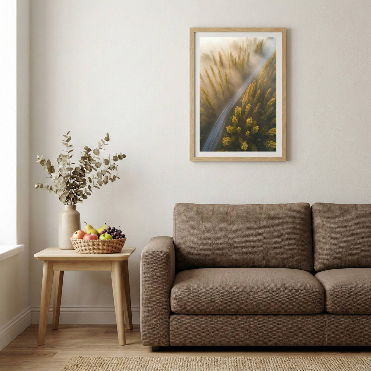 Aerial view of a road through golden trees lit by streaming morning sunbeams — wooden-frame wall art print, 20×30 in