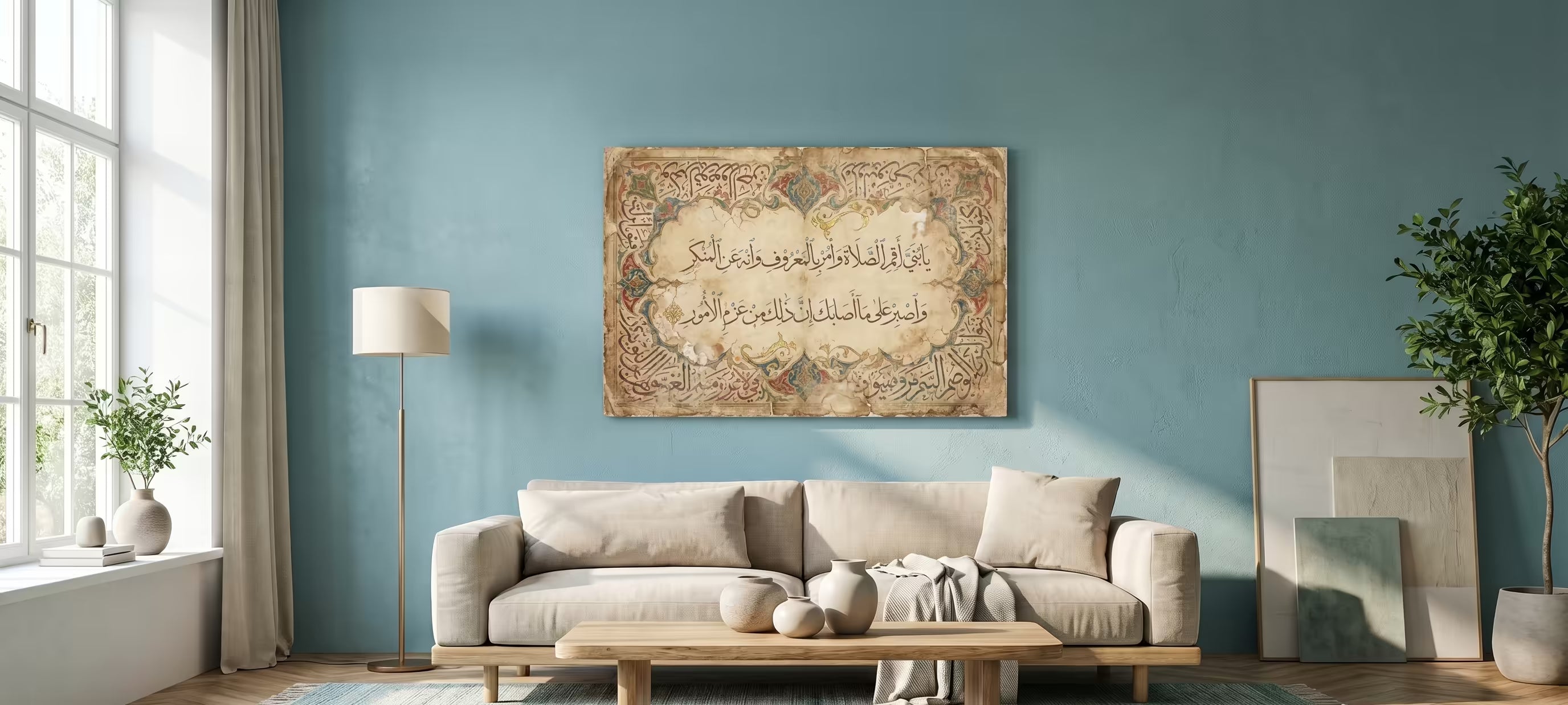 A framed vintage-style Islamic calligraphy canvas print hangs on a blue wall above a beige sofa in a modern living room setting.