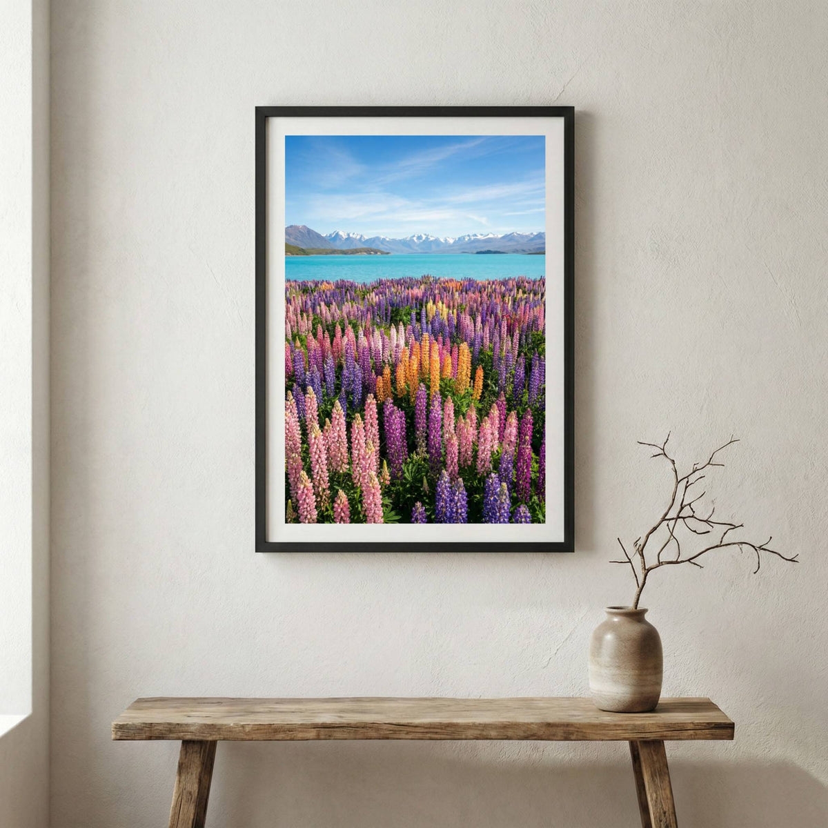 Purple lupine flowers blooming along a turquoise lakeshore beneath the mountains — wooden frame canvas wall art print, 12×18 in