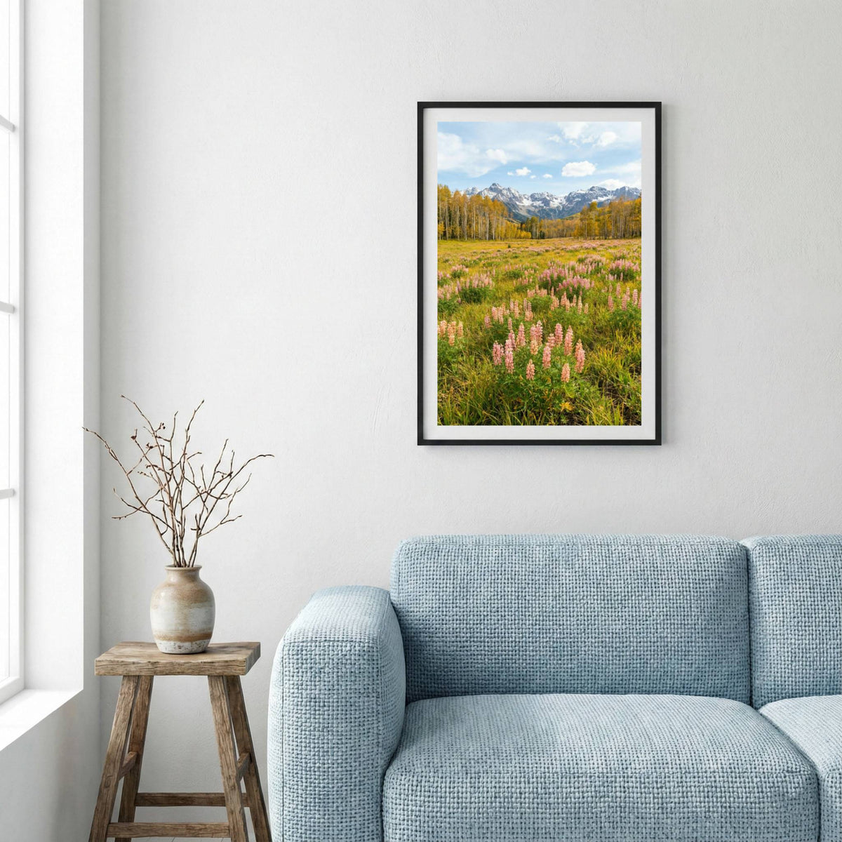 Pink lupine flowers across a green meadow with snow-capped peaks beyond — framed canvas wall art in a wooden frame, 16×24 in