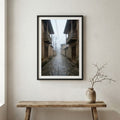 Traditional stone and wood village houses on a misty, terraced mountainside — wooden frame canvas wall art print, 12×18 in