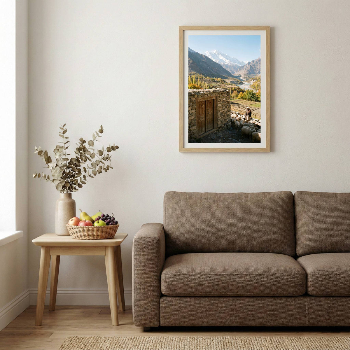 Shepherd guiding a flock of sheep past a stone doorway above a terraced river valley — wooden-frame wall art print, 20×30 in