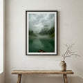 Snow-covered wooden cabin set against jagged, snow-capped mountains — wooden frame canvas wall art print, 12×18 in