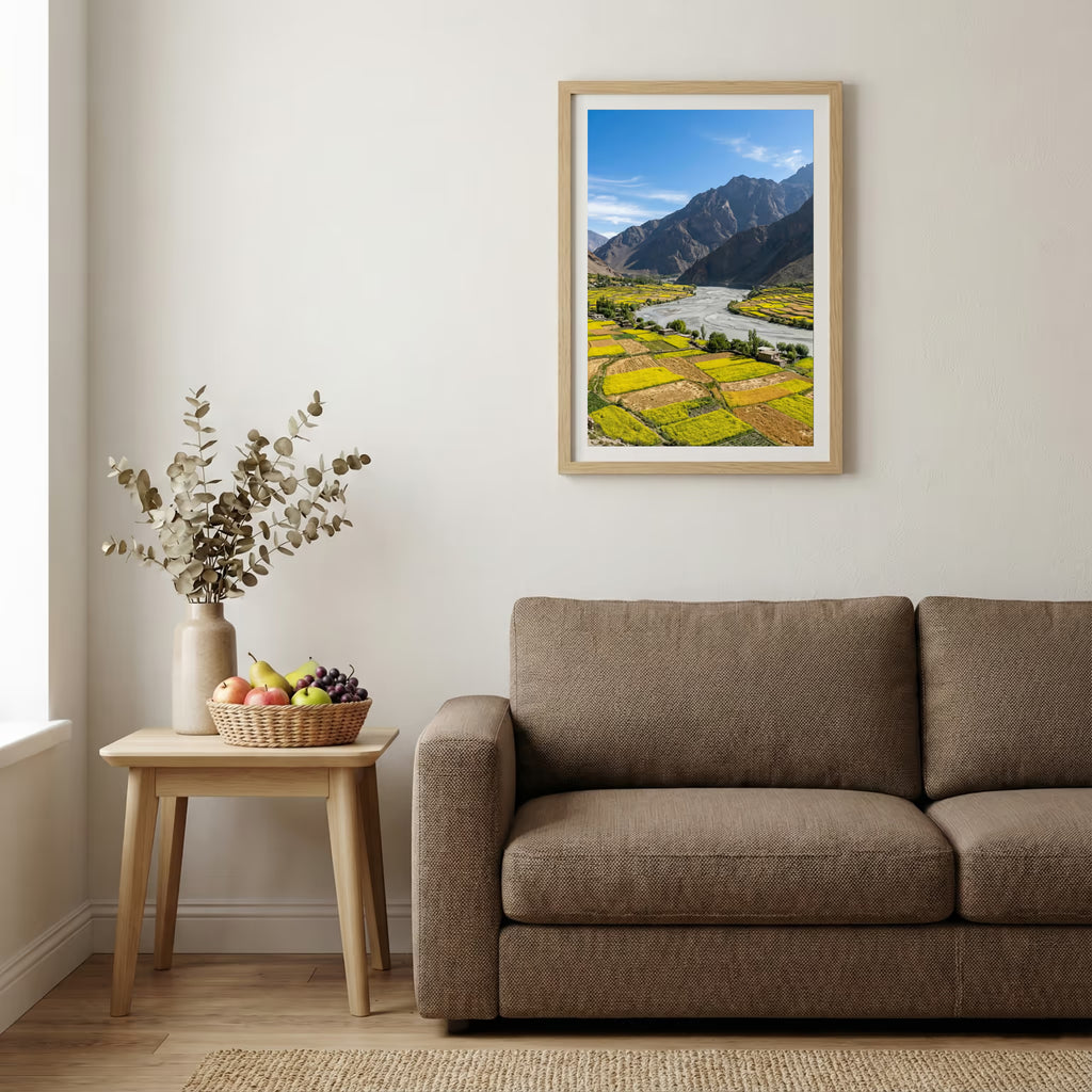 Snow-covered pine trees along a turquoise river beneath jagged snowy peaks — wooden-frame wall art print, 20×30 in
