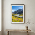 Snow-covered pine trees along a turquoise river beneath jagged snowy peaks — wooden frame canvas wall art print, 12×18 in