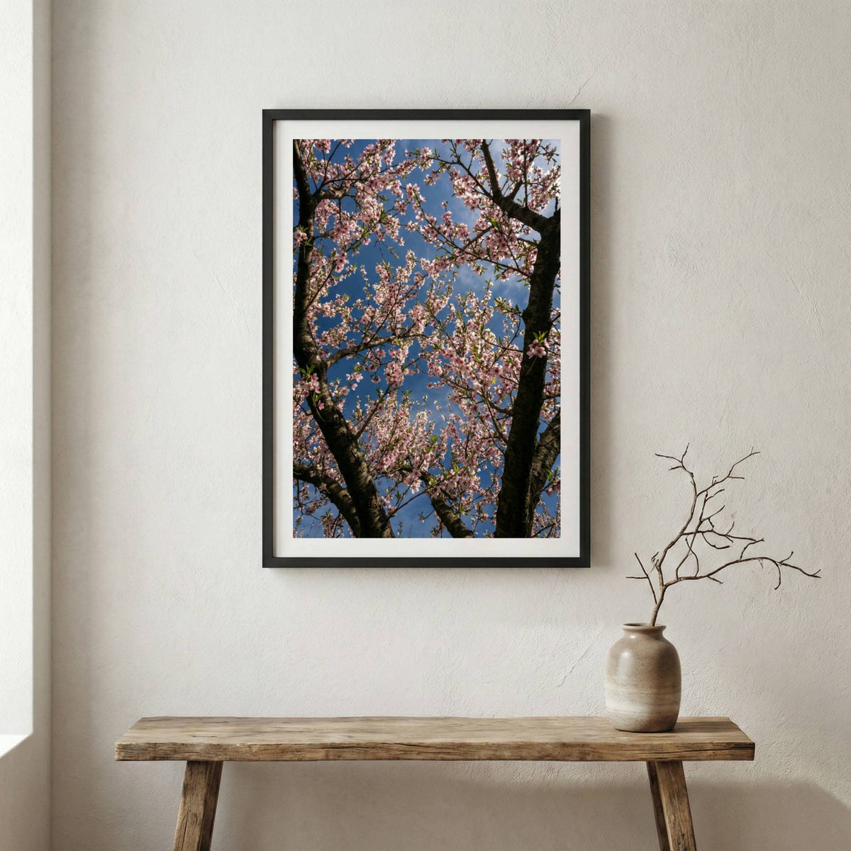 Dense pink spring blossoms filling the frame beneath a blue sky — wooden frame canvas wall art print, 12×18 in