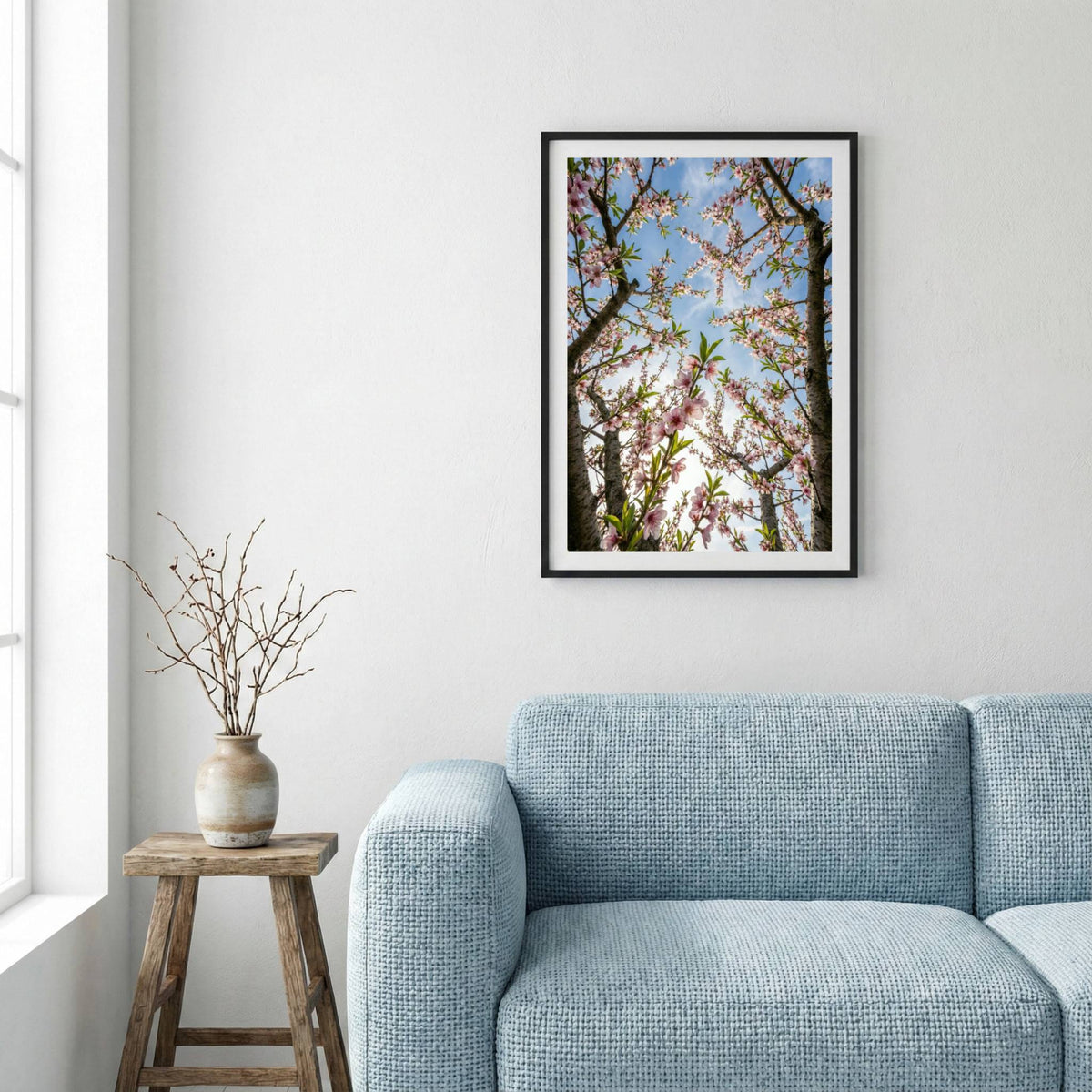 Sunlit pink and white blossom branches glowing against a clear blue sky — framed canvas wall art in a wooden frame, 16×24 in