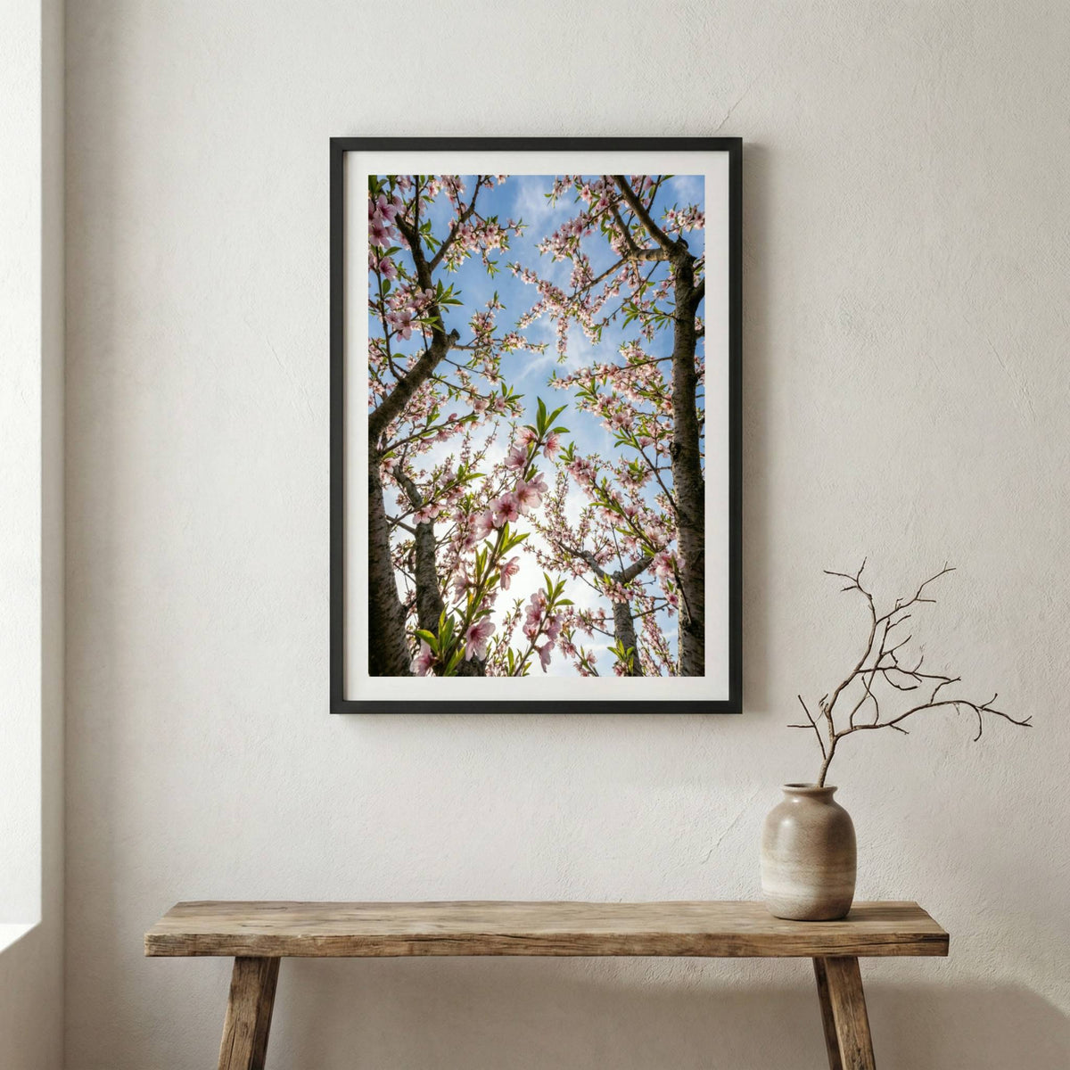 Sunlit pink and white blossom branches glowing against a clear blue sky — wooden frame canvas wall art print, 12×18 in