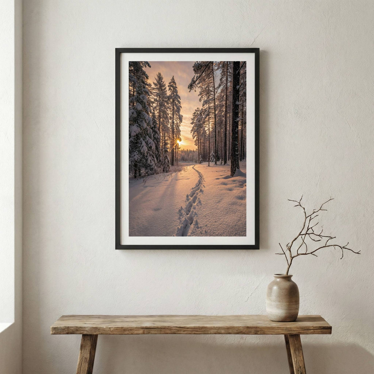 Footprints trailing down a snowy forest path lit by low, golden sun rays — wooden frame canvas wall art print, 12×18 in