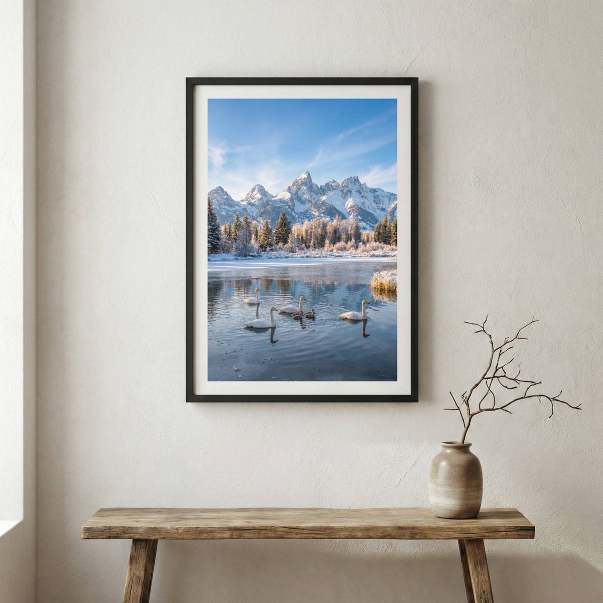Swans gliding across a frozen lake beneath snow-capped mountains — wooden frame canvas wall art print, 12×18 in