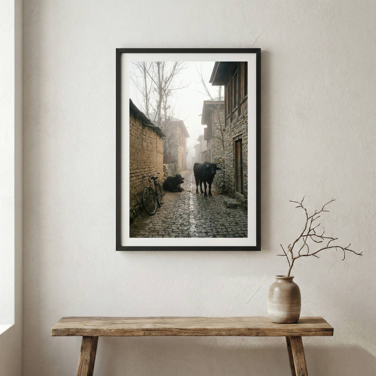 Foggy village alley at dawn with a bicycle and cattle along a stone lane — wooden frame canvas wall art print, 12×18 in