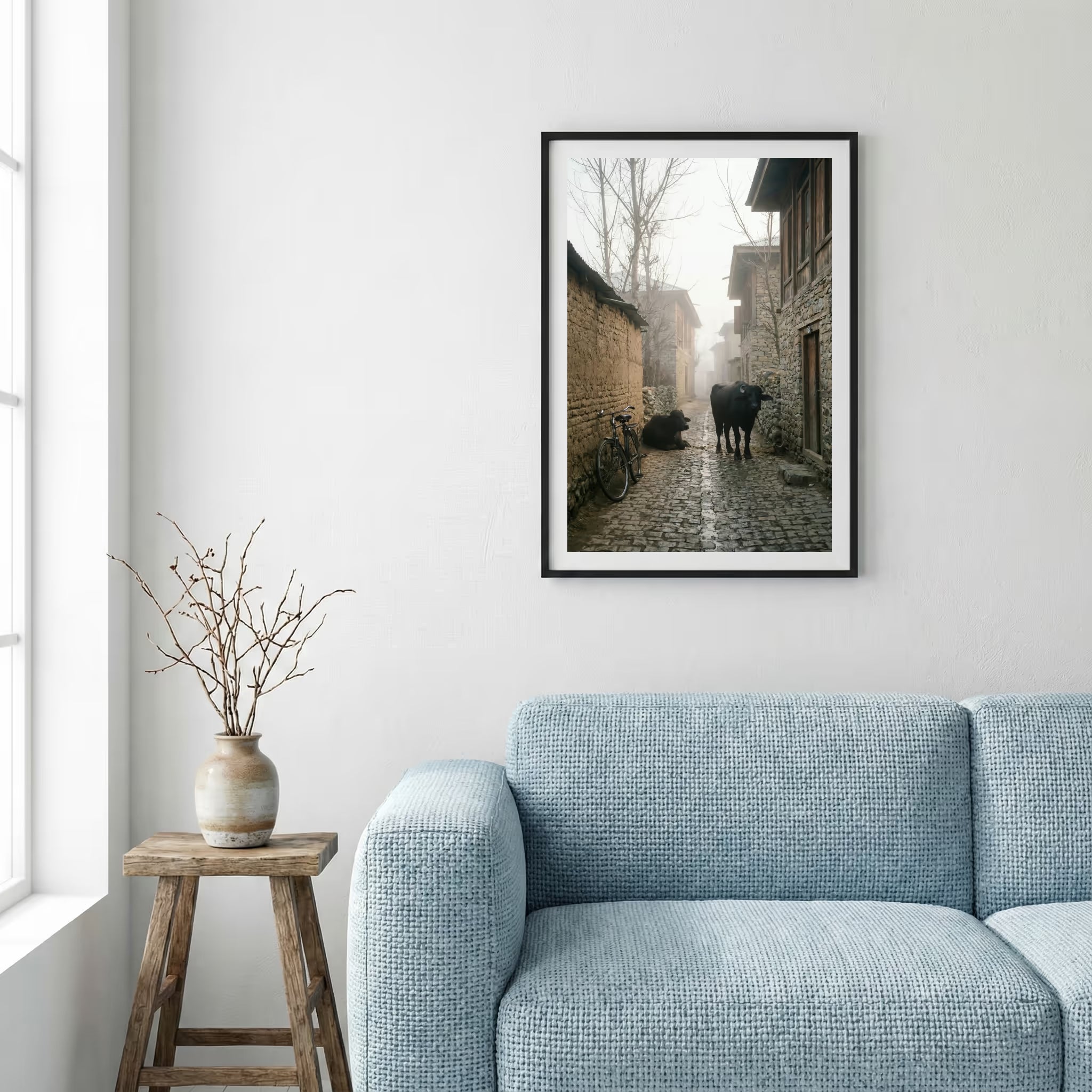 Foggy village alley at dawn with a bicycle and cattle along a stone lane — framed canvas wall art in a wooden frame, 16×24 in