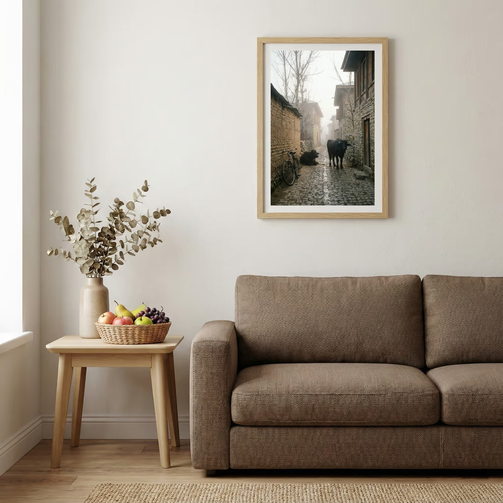 Foggy village alley at dawn with a bicycle and cattle along a stone lane — wooden-frame wall art print, 20×30 in