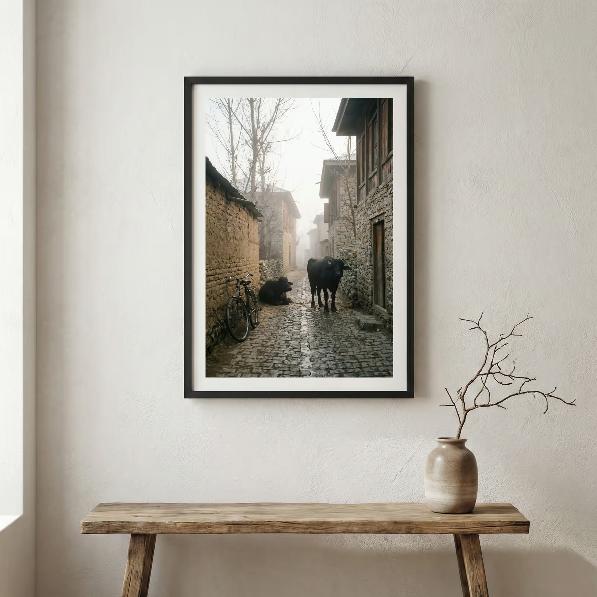 Foggy village alley at dawn with a bicycle and cattle along a stone lane — wooden frame canvas wall art print, 12×18 in