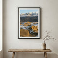Green river valley with purple wildflowers in the foreground and snow-capped peaks beyond — wooden frame canvas wall art print, 12×18 in
