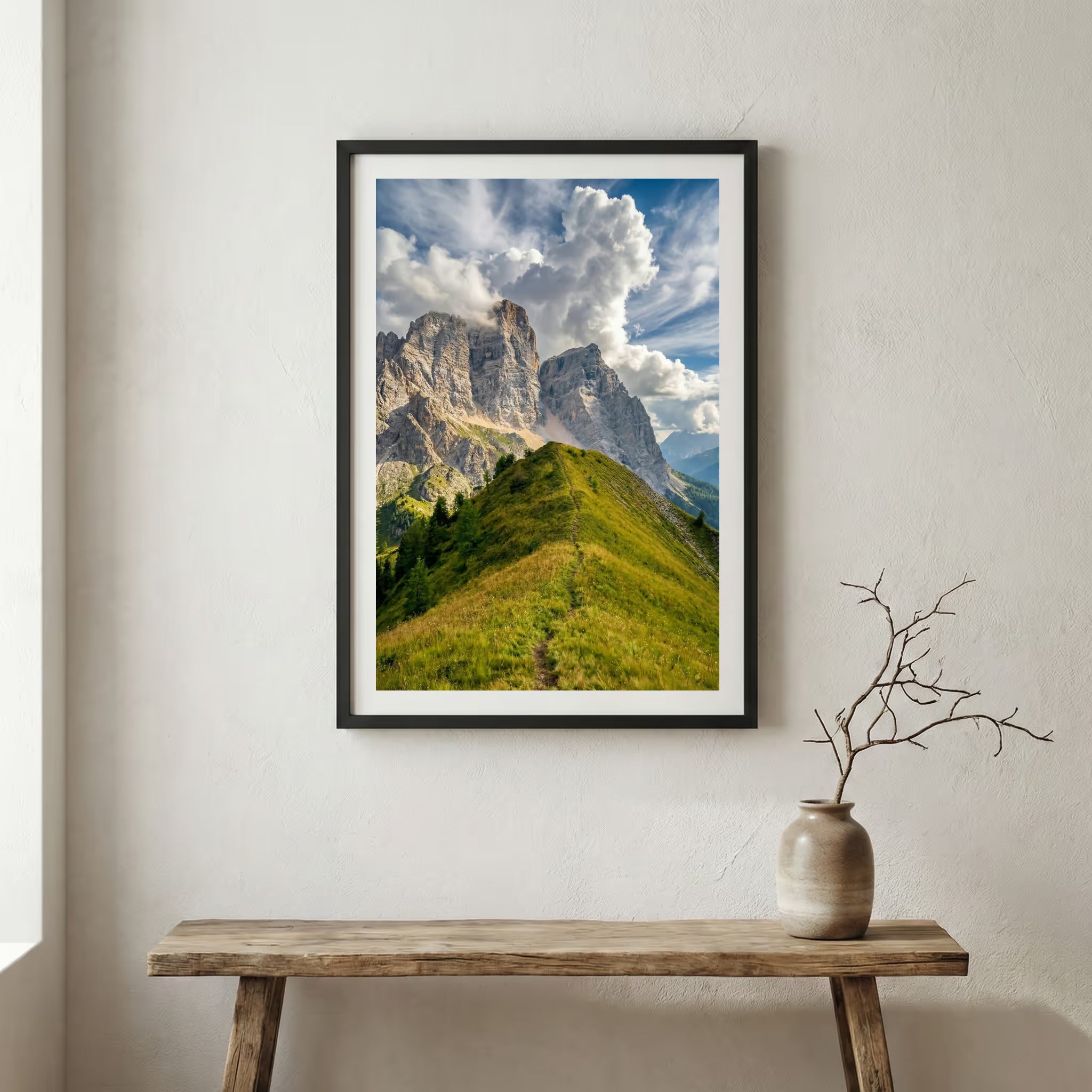 Jagged rocky peak rising above a green grassy ridge trail under a blue sky — wooden frame canvas wall art print, 12×18 in