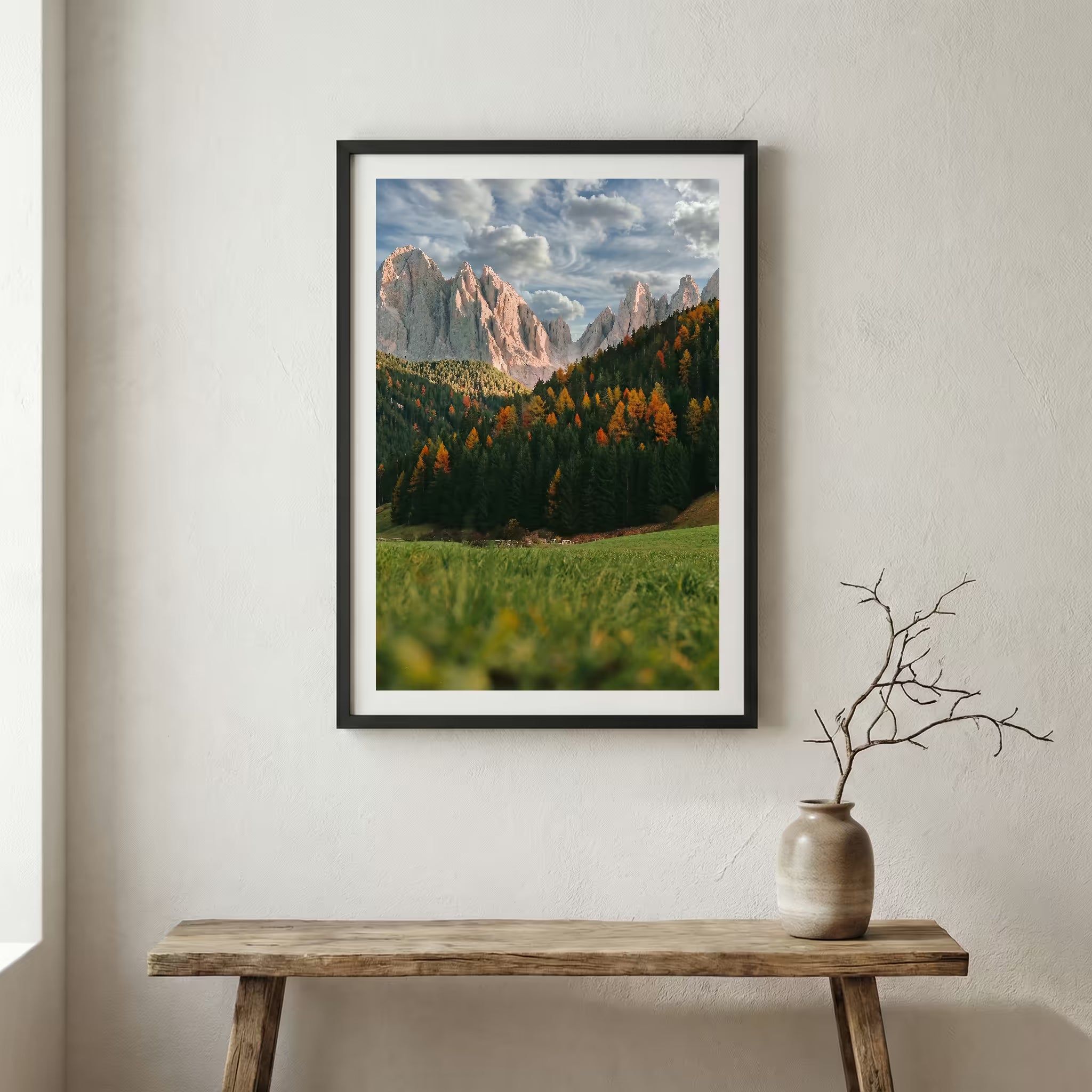 Jagged alpine peaks rising above a green valley dotted with autumn-colored trees — wooden frame canvas wall art print, 12×18 in