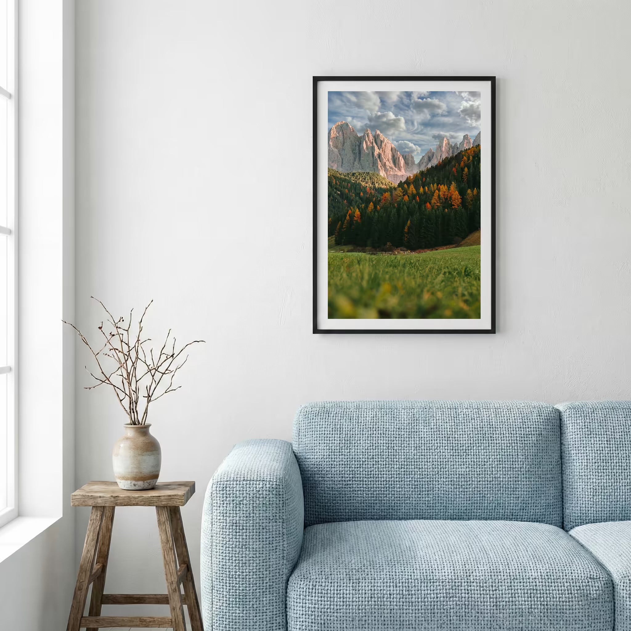 Jagged alpine peaks rising above a green valley dotted with autumn-colored trees — framed canvas wall art in a wooden frame, 16×24 in