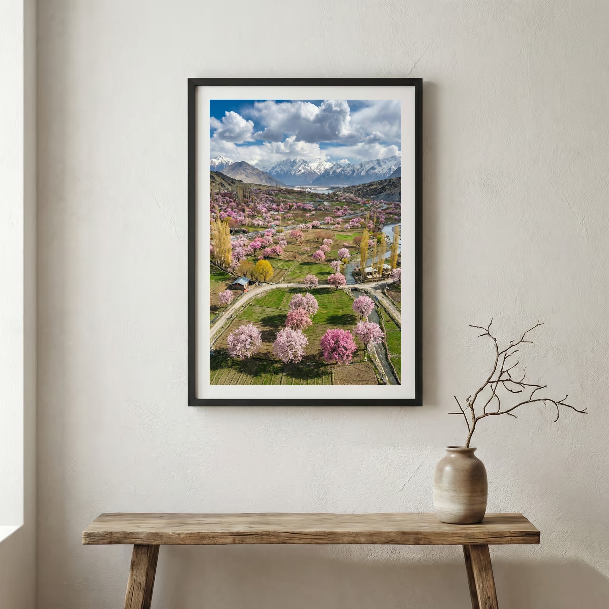 Aerial view of a valley in full bloom with pink blossom trees and a mountain backdrop — wooden frame canvas wall art print, 12×18 in