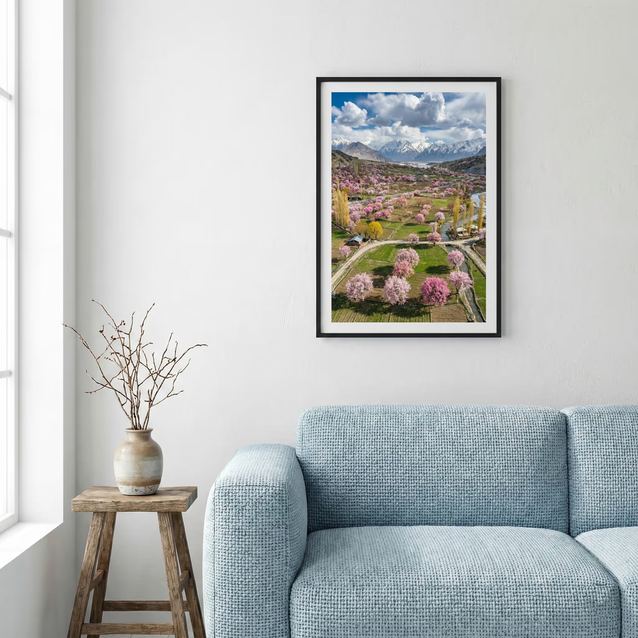 Aerial view of a valley in full bloom with pink blossom trees and a mountain backdrop — framed canvas wall art in a wooden frame, 16×24 in