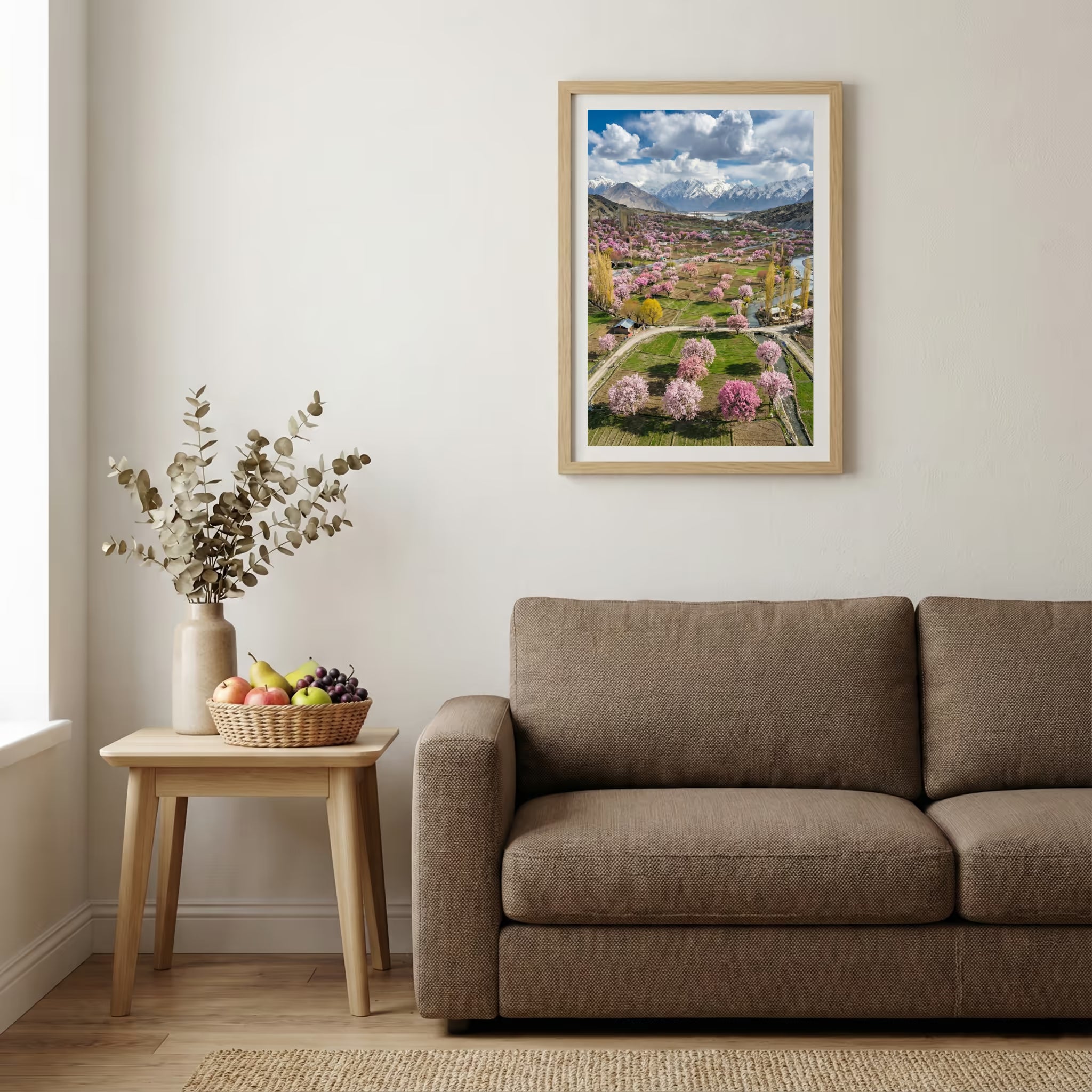Aerial view of a valley in full bloom with pink blossom trees and a mountain backdrop — wooden-frame wall art print, 20×30 in