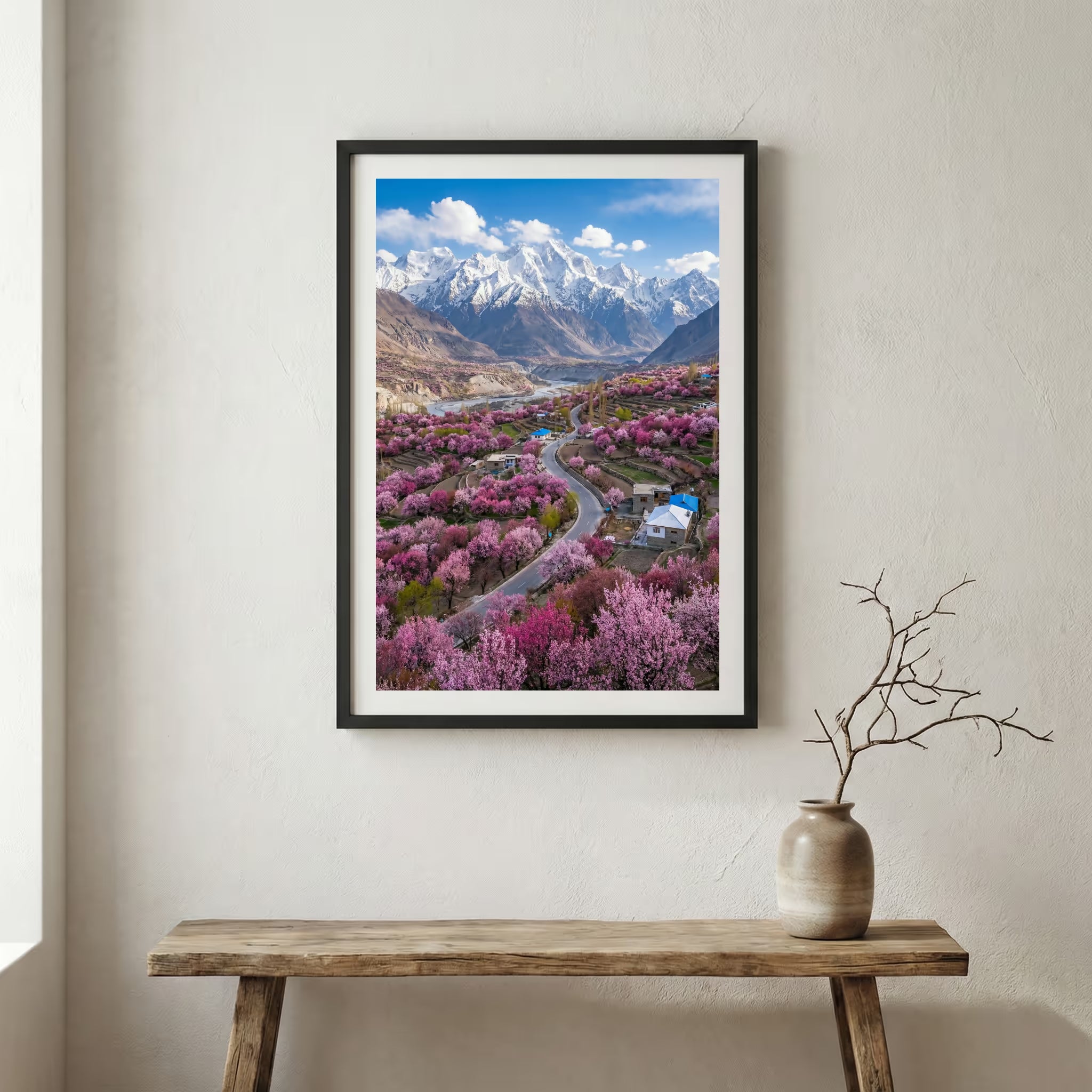 Aerial view of a blossoming valley with a road and a snow-capped mountain beyond — wooden frame canvas wall art print, 12×18 in