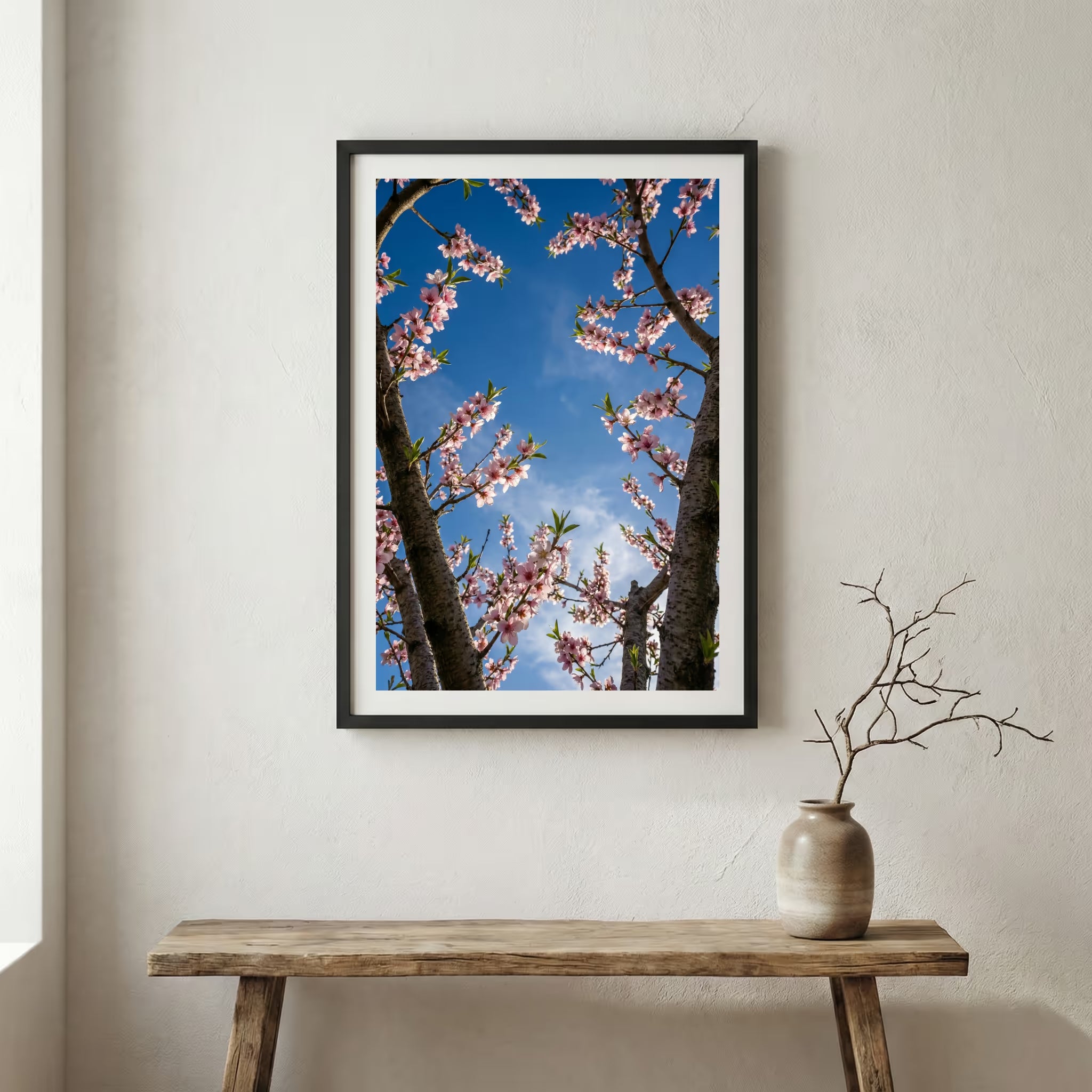 Pink blossom branches reaching into a vivid blue sky — wooden frame canvas wall art print, 12×18 in