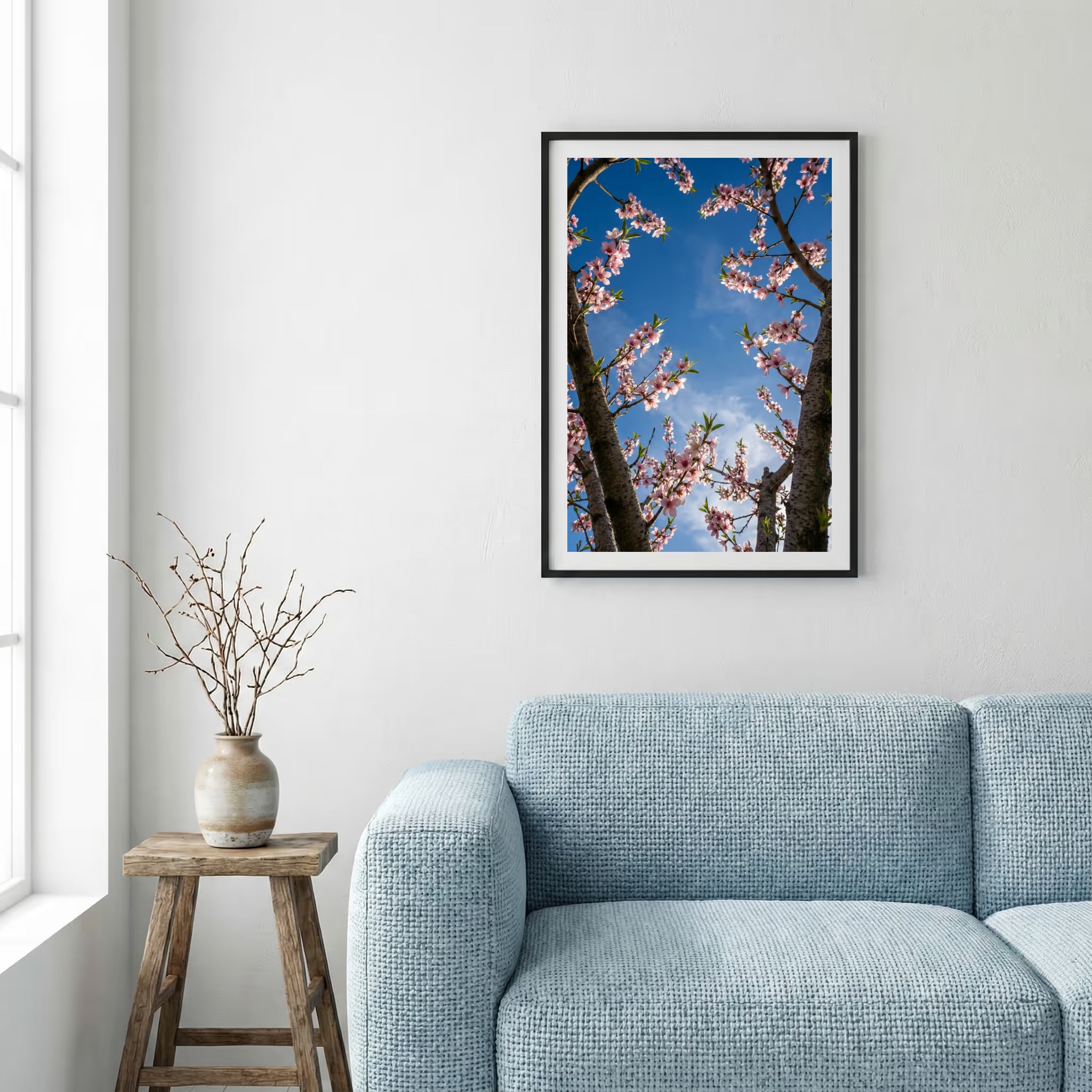 Pink blossom branches reaching into a vivid blue sky — framed canvas wall art in a wooden frame, 16×24 in
