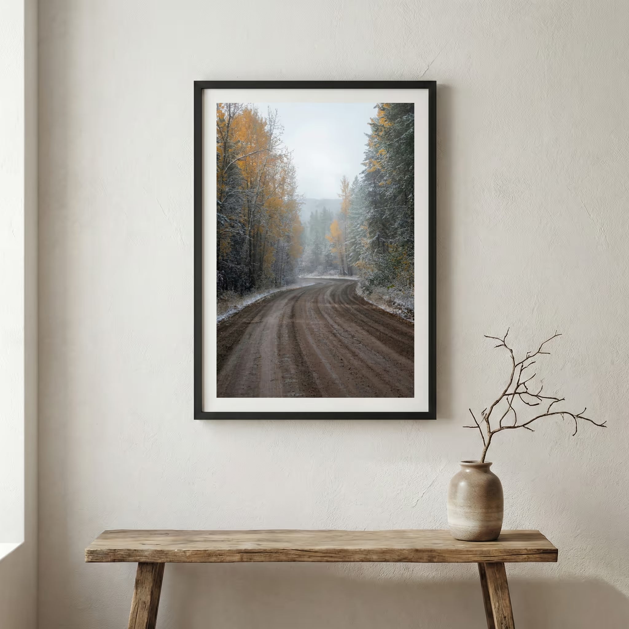 Dirt forest road scattered with autumn leaves and an early dusting of snow — wooden frame canvas wall art print, 12×18 in