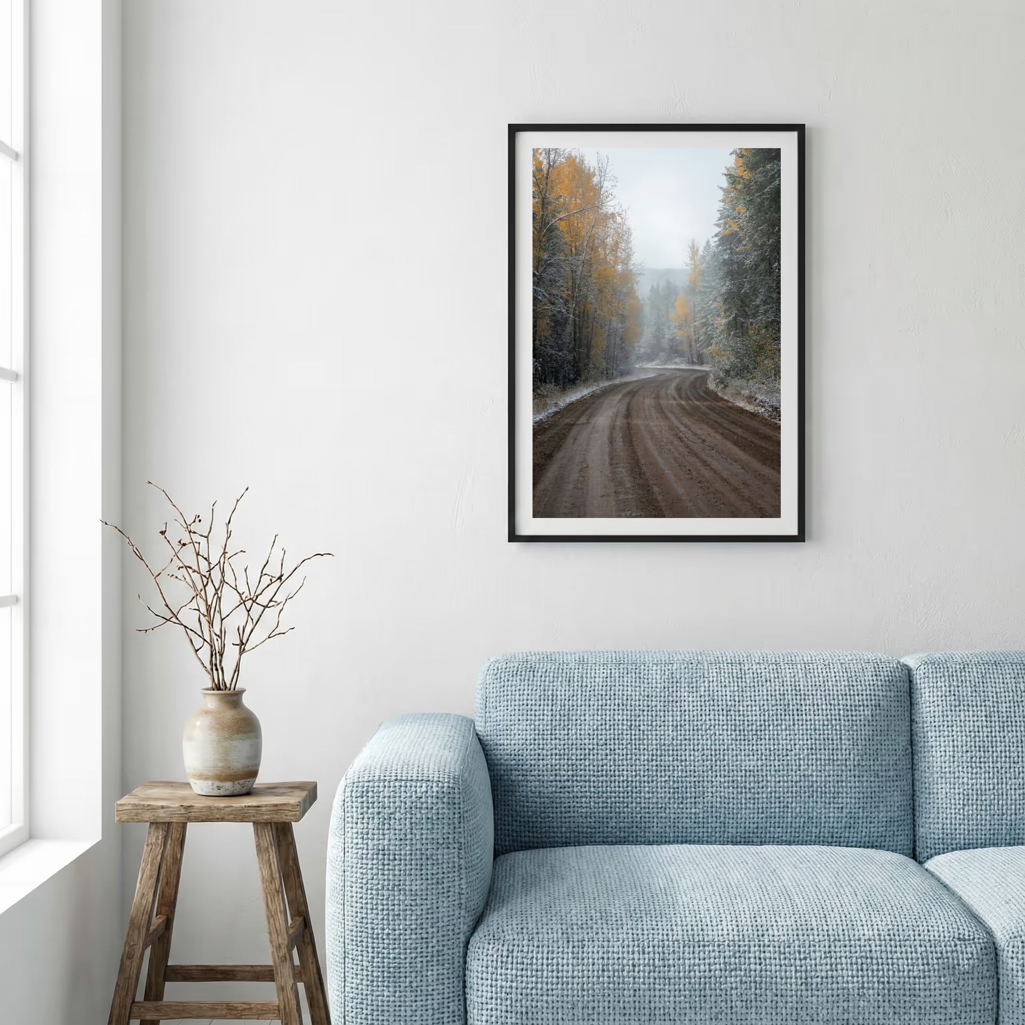 Dirt forest road scattered with autumn leaves and an early dusting of snow — framed canvas wall art in a wooden frame, 16×24 in