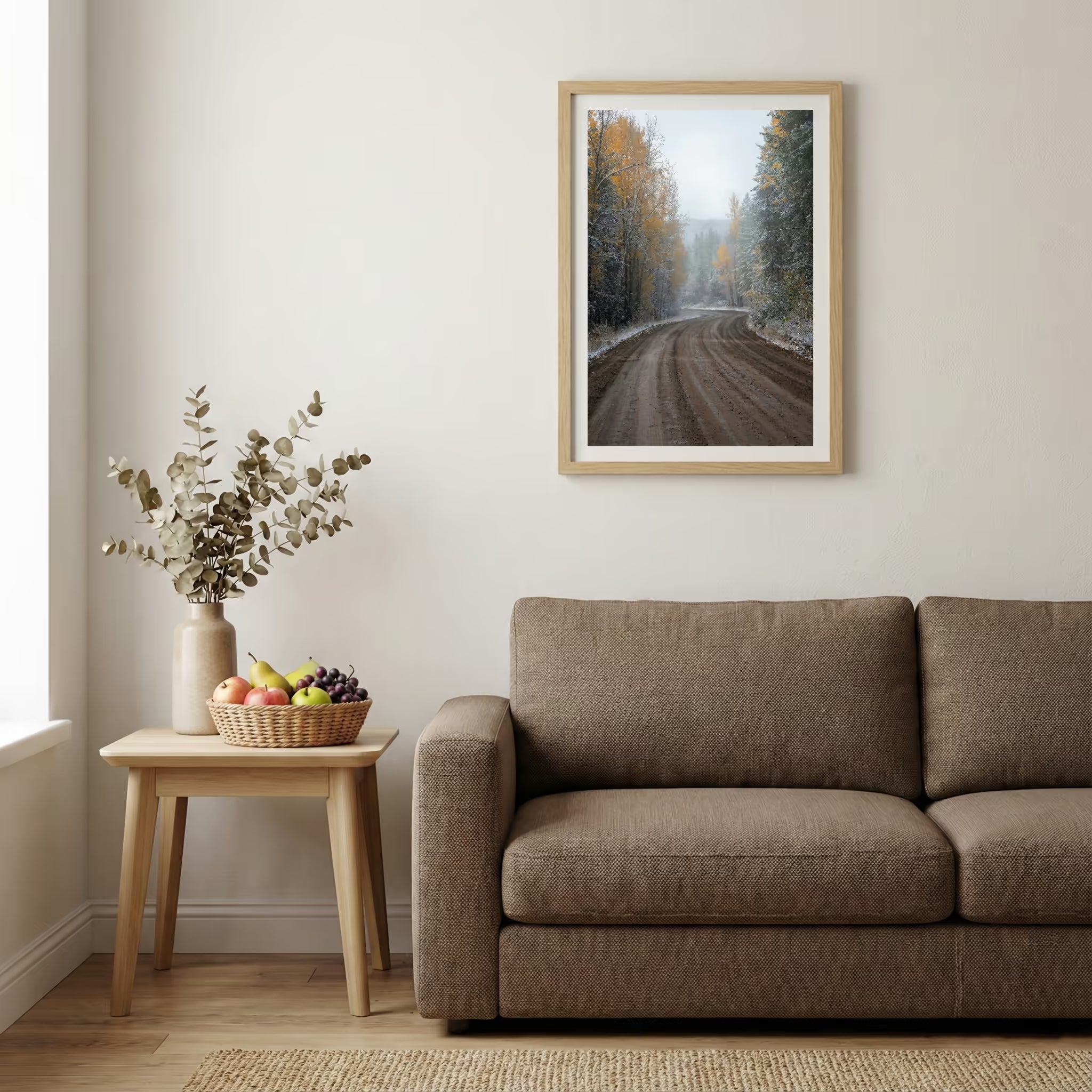 Dirt forest road scattered with autumn leaves and an early dusting of snow — wooden-frame wall art print, 20×30 in
