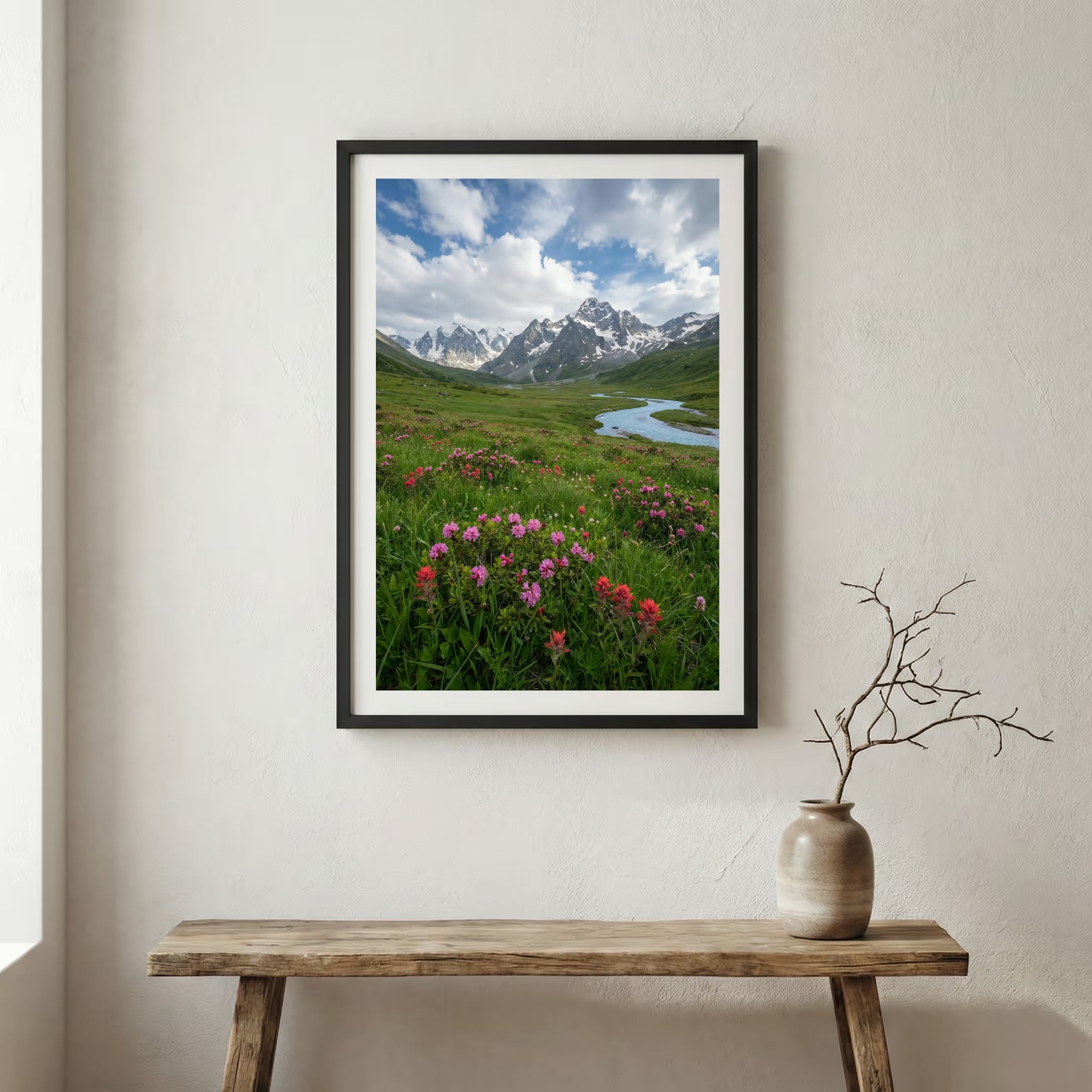 Pink wildflowers beside a mountain stream with snow-capped peaks beyond — wooden frame canvas wall art print, 12×18 in