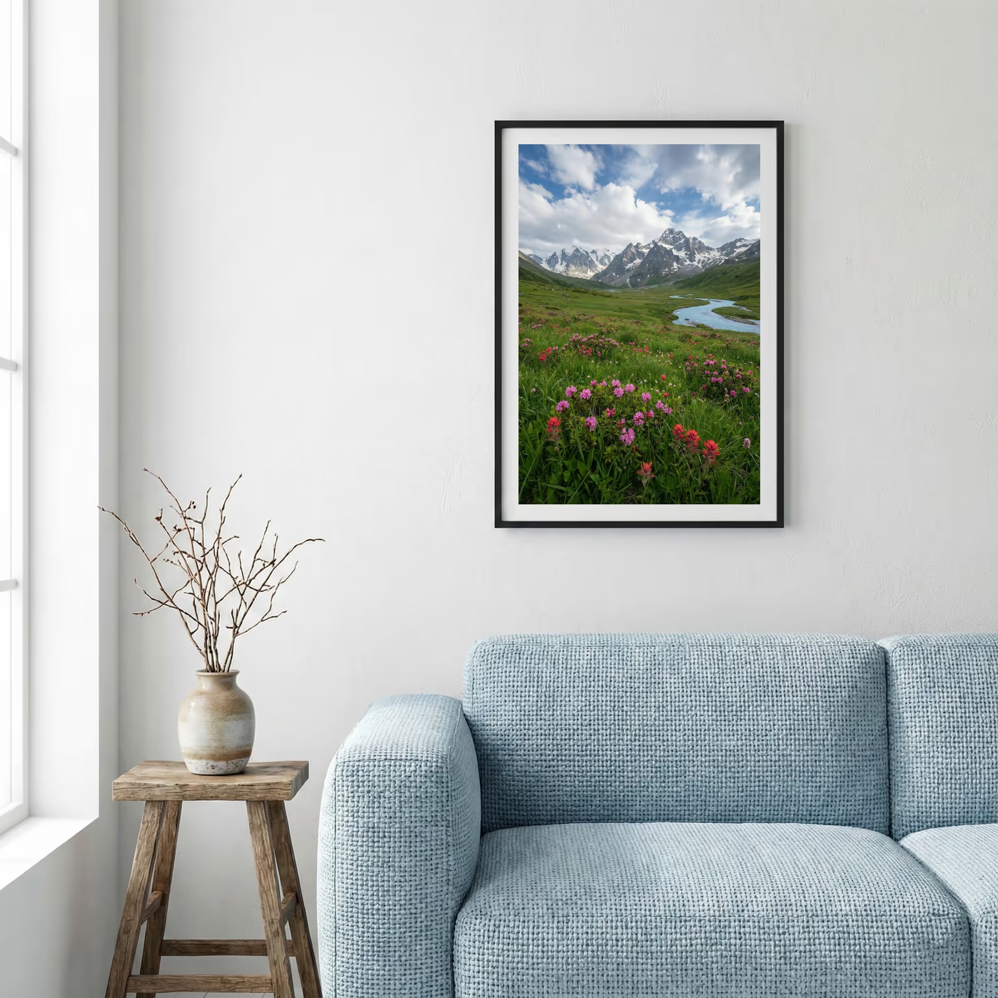 Pink wildflowers beside a mountain stream with snow-capped peaks beyond — framed canvas wall art in a wooden frame, 16×24 in