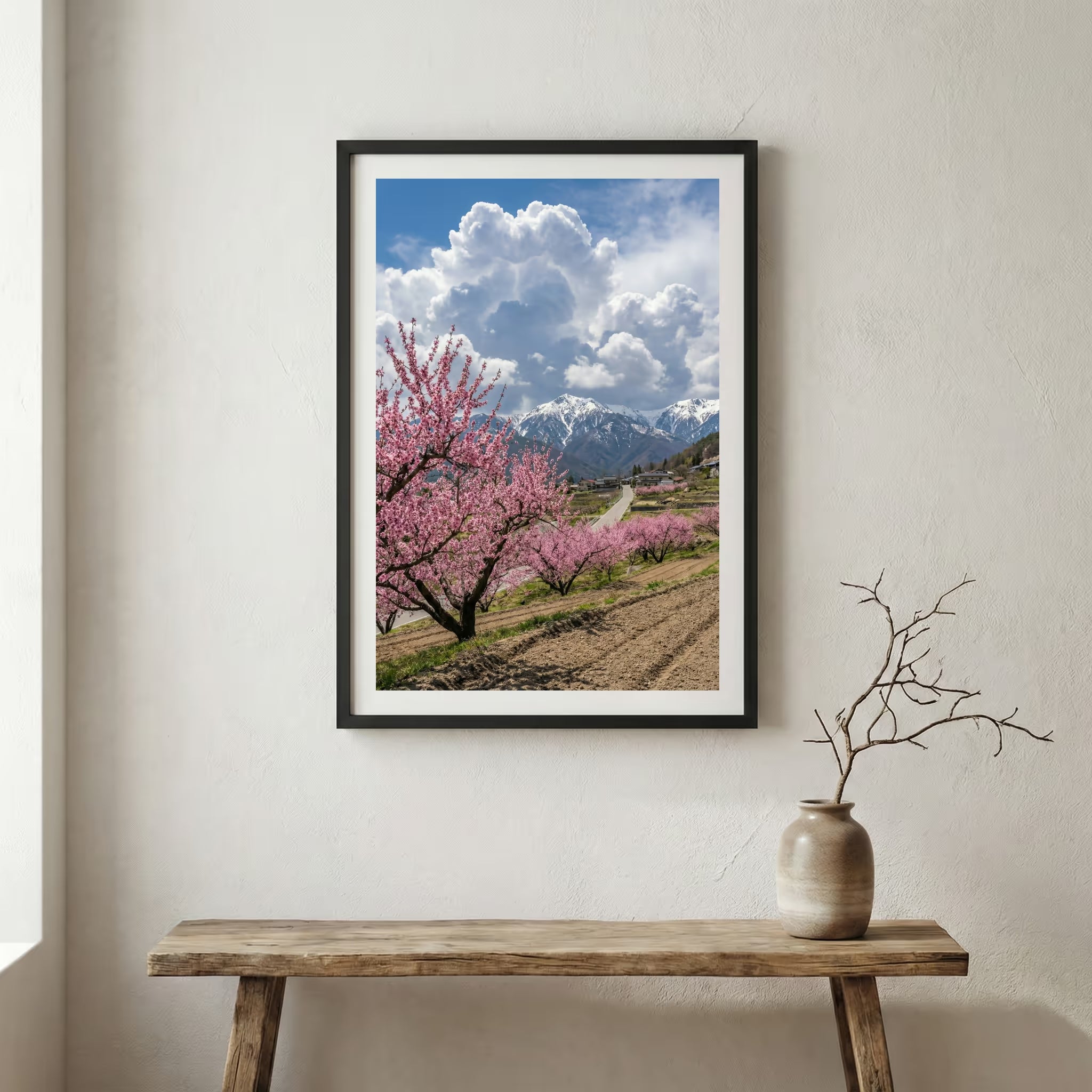 Blossoming trees lining a hillside path under a bright, cloud-filled blue sky — wooden frame canvas wall art print, 12×18 in