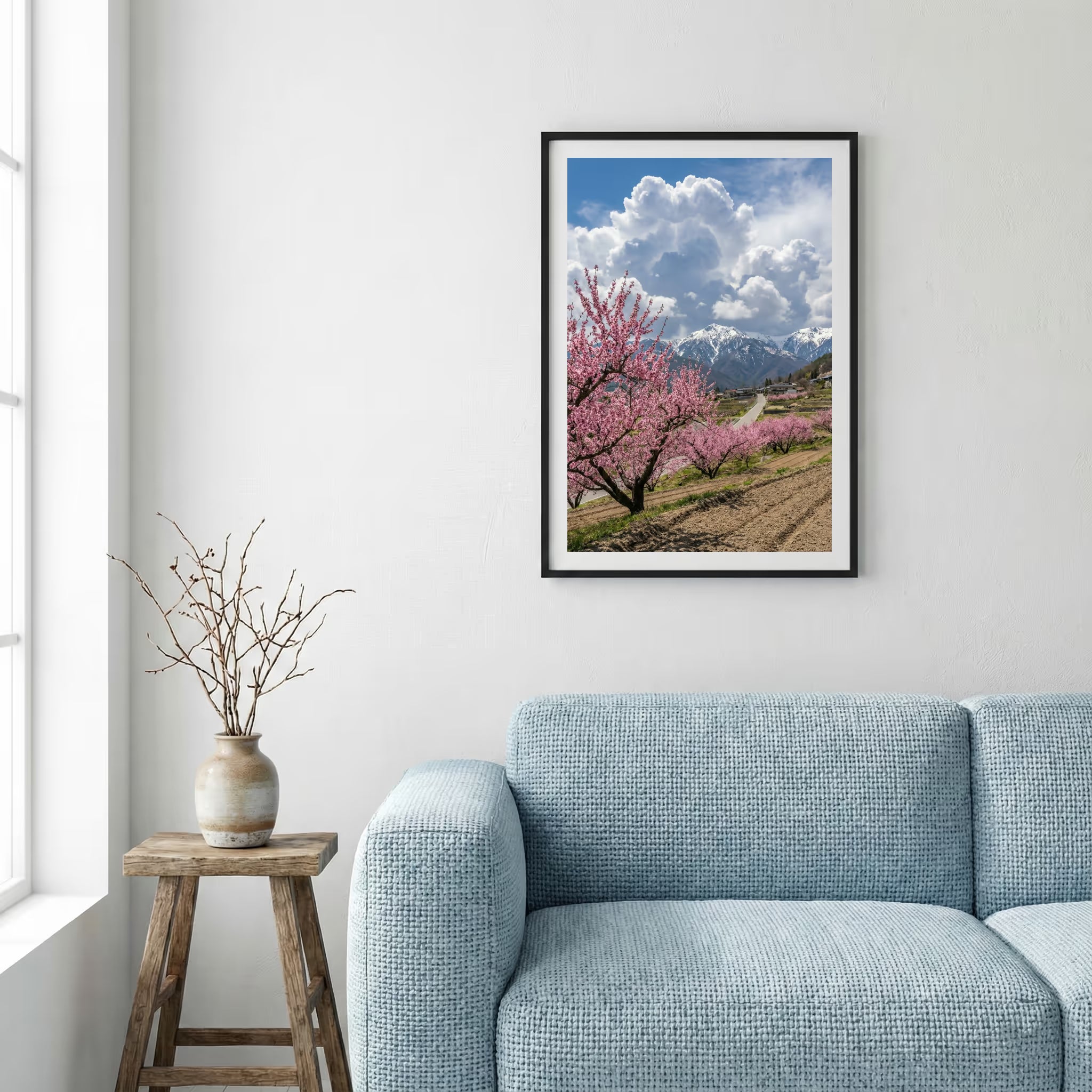 Blossoming trees lining a hillside path under a bright, cloud-filled blue sky — framed canvas wall art in a wooden frame, 16×24 in